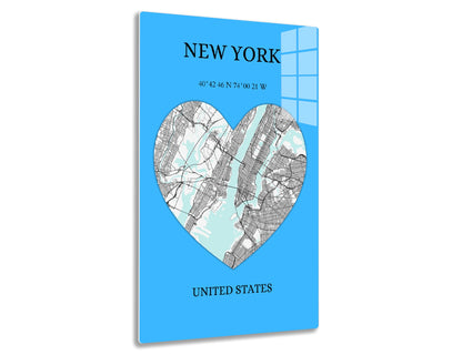 A heart-shaped map of New York City in shades of blue and gray, depicting the city's streets and boroughs. The text reads "NEW YORK 40°42'46 N 74°00'21 W
