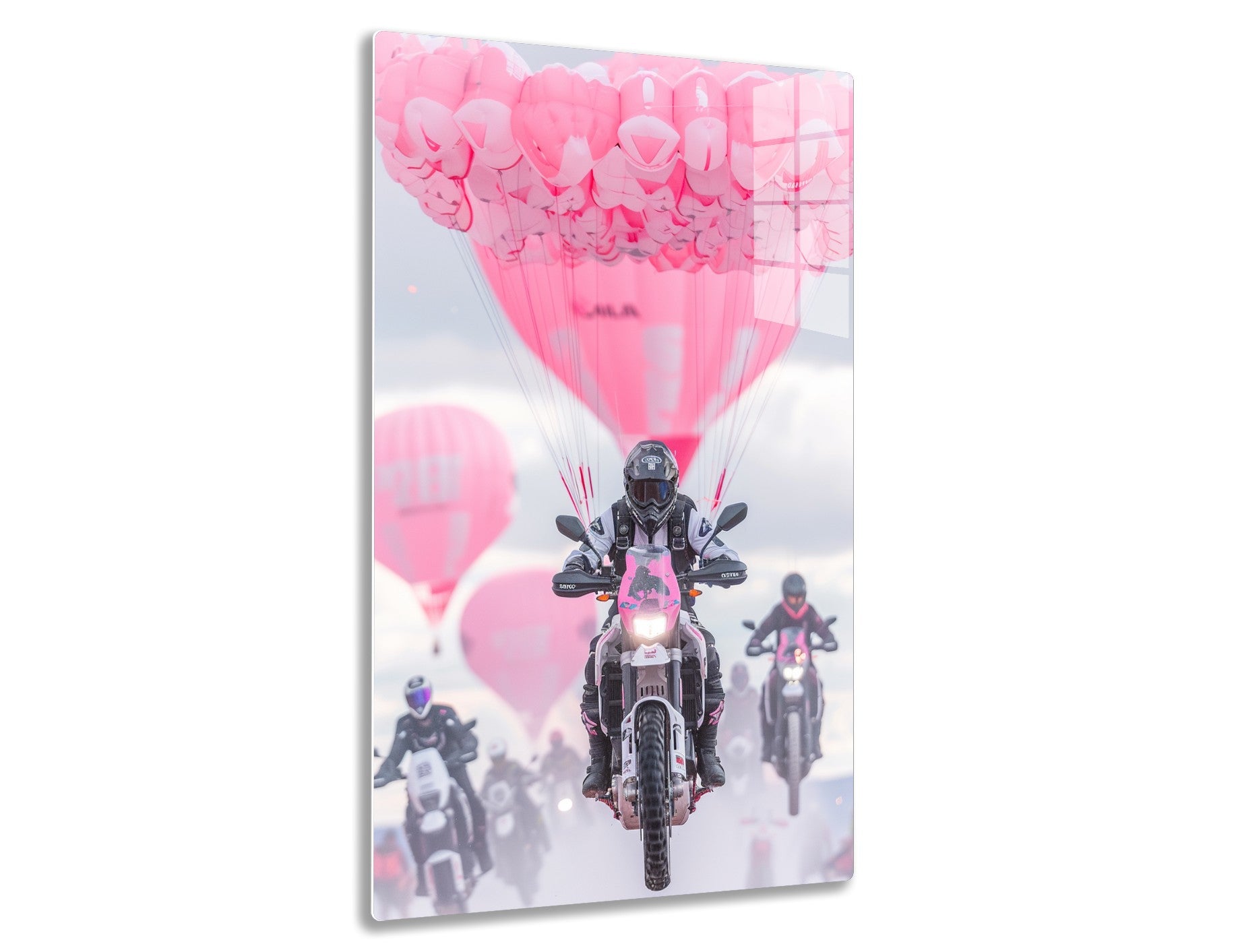 A motorcyclist rides amid a sky filled with dozens of pink balloons, creating a surreal and whimsical scene.
