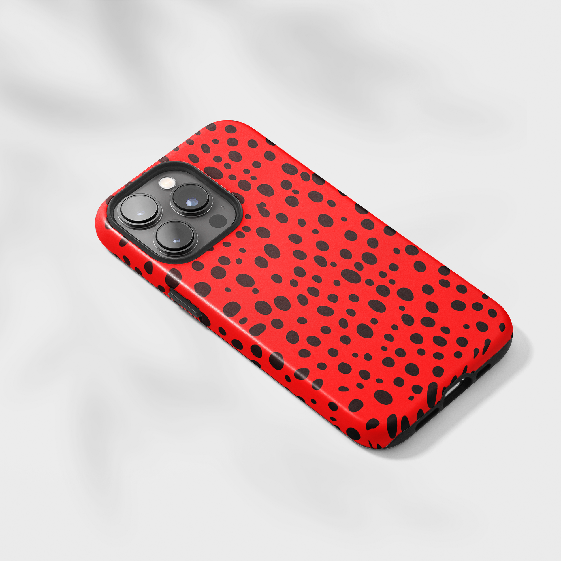 Dotted Delight - Red (iPhone Case 11-15)Elevate your iPhone's style with Rima's Red backdrop with varied black dots case. Sleek, durable protection for models 11-15. Free US shipping.RimaGallery