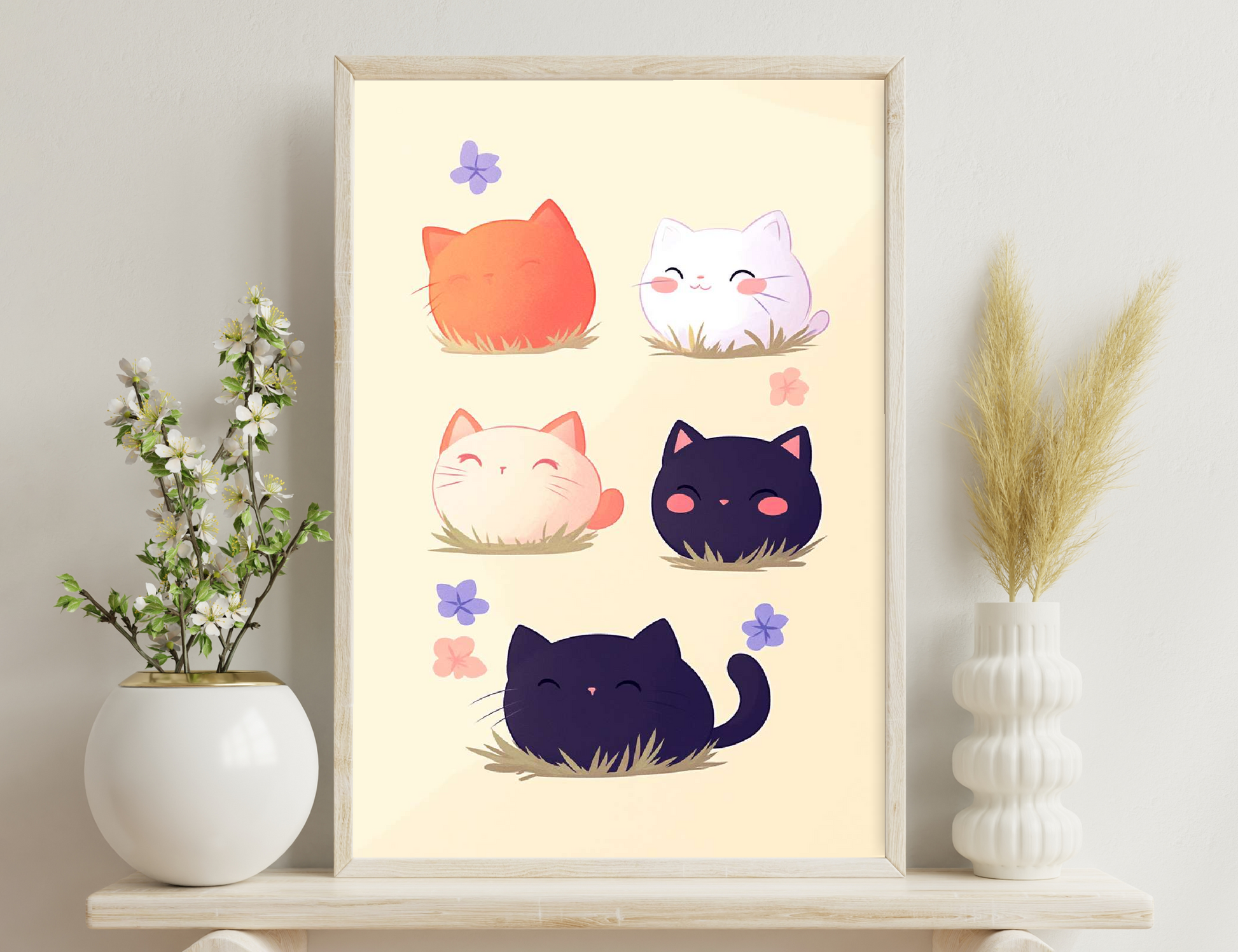 Cartoon illustration of five chubby cats in different colors - orange, white, cream, black, and navy blue - sitting in grass with purple and pink flower petals around them.
