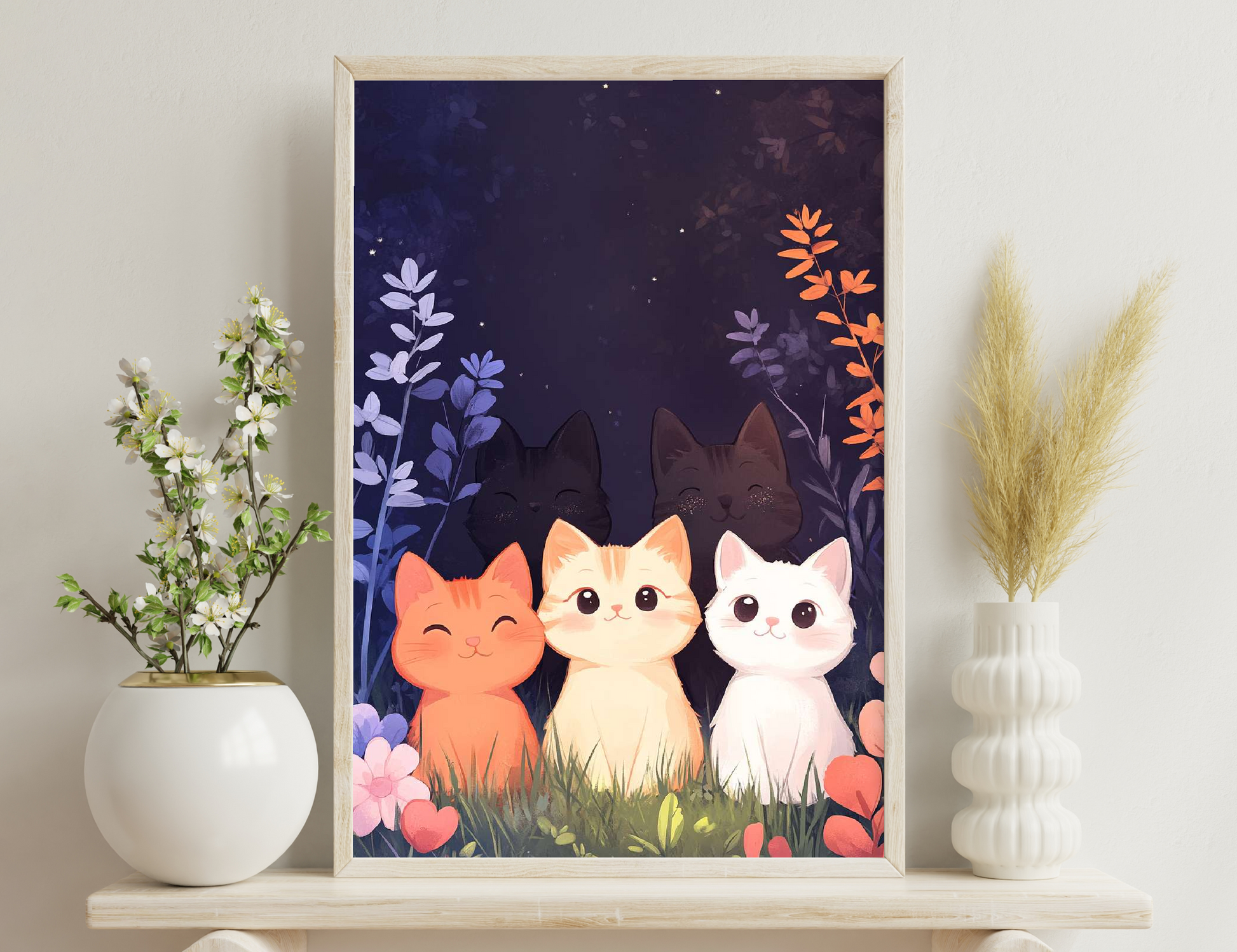 Three adorable cartoon cats, one orange, one cream, and one white, sit together in a grassy field with blue and orange flowers under a starry night sky.
