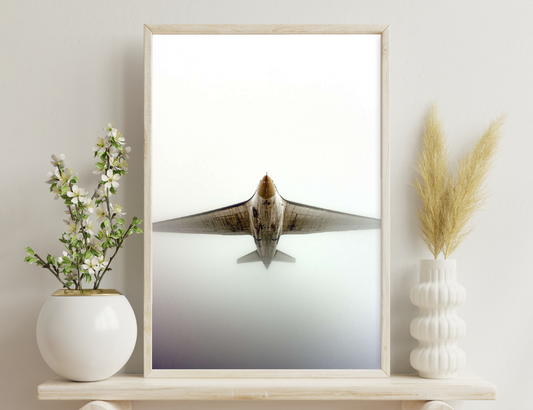 An aircraft's nose and wings are shown from a frontal perspective, with a dirty and weathered appearance against a plain background, evoking a sense of wear and age on the aircraft.
