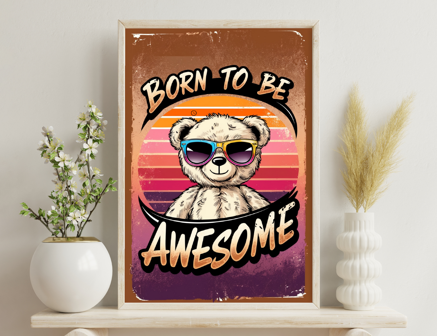 A retro-styled illustration featuring a smiling teddy bear wearing colorful sunglasses against a sunset gradient background, with text that reads "Born to be Awesome".
