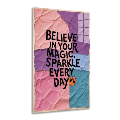 Inspirational quote "Believe in your magic, sparkle every day" in black text on pink, purple, and blue torn paper background with orange paw print.
