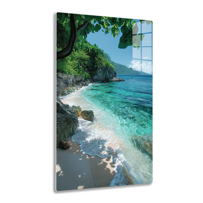 A tranquil tropical beach with turquoise waters lapping against rocky shores, framed by lush green foliage and mountains in the distance under a cloudy sky.
