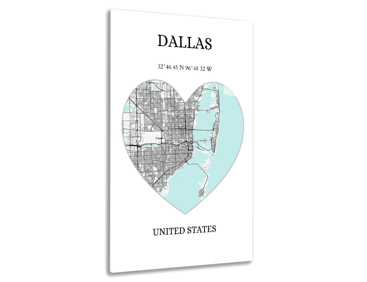 Map of Dallas city in the shape of a heart with street grids on one side and water bodies on the other side, with the geographic coordinates and country name mentioned.
